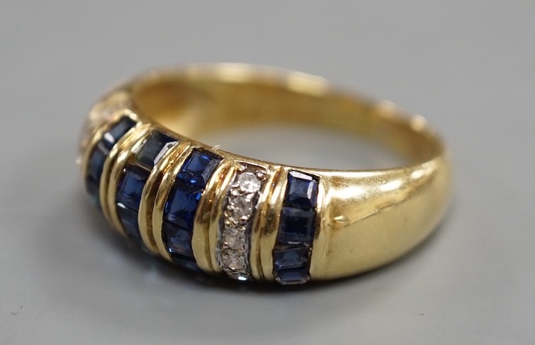A modern yellow metal, sapphire chip and diamond chip set half hoop cluster ring, size M/N, ross weight 3.6 grams(two sapphires missing).